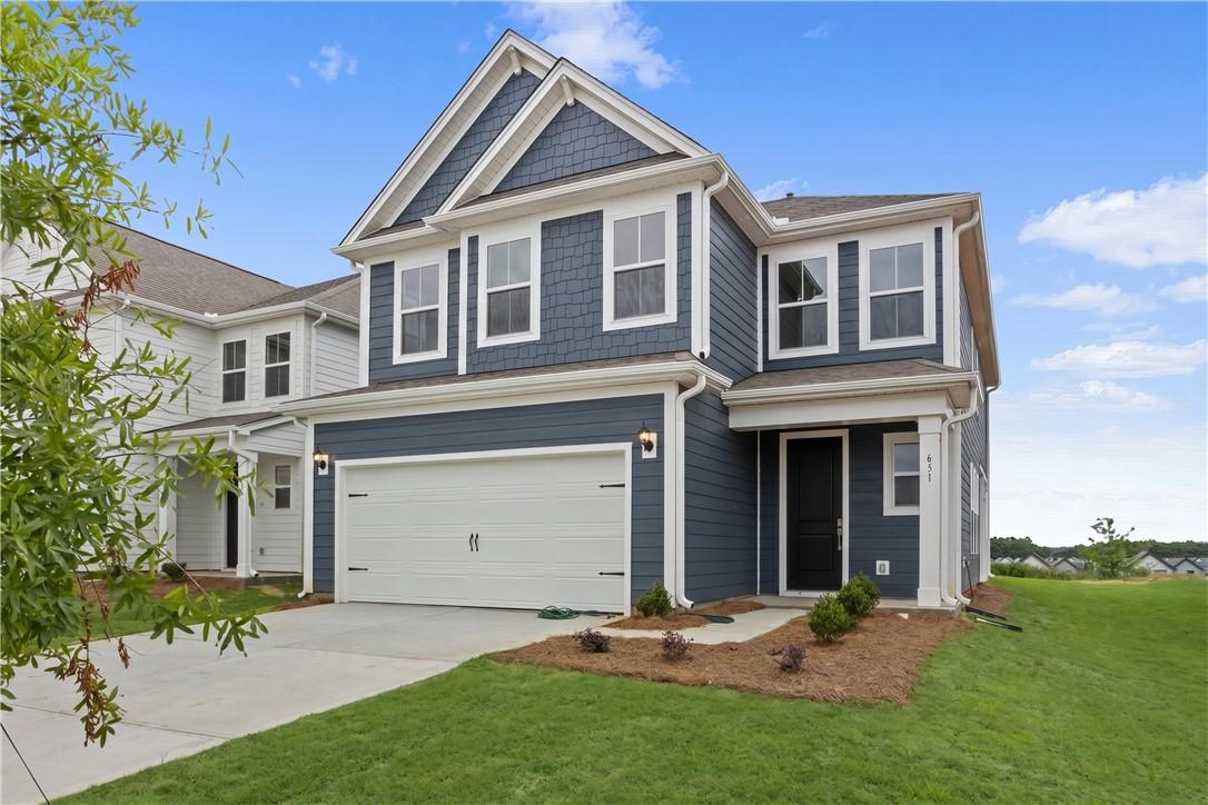 Image 2: A handsome two-story residence with a classic gabl