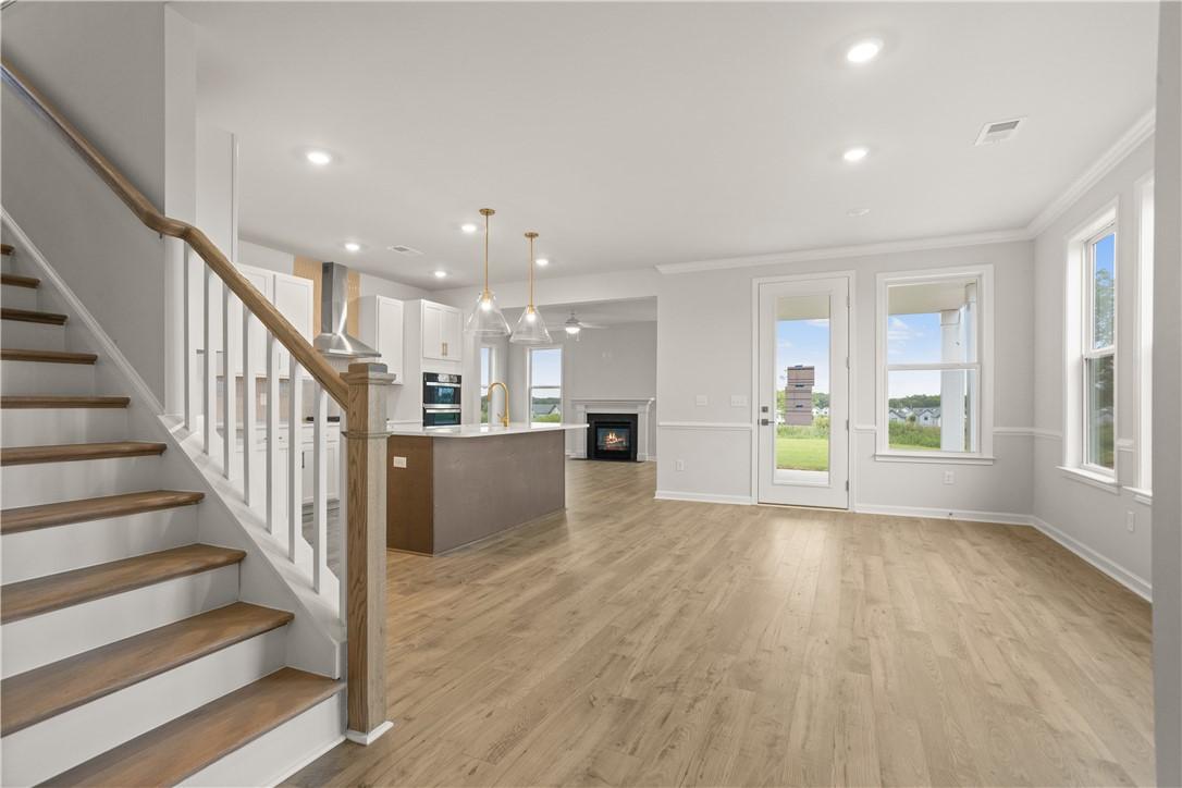 Image 4: Hardwood floors stretch across this open-concept l
