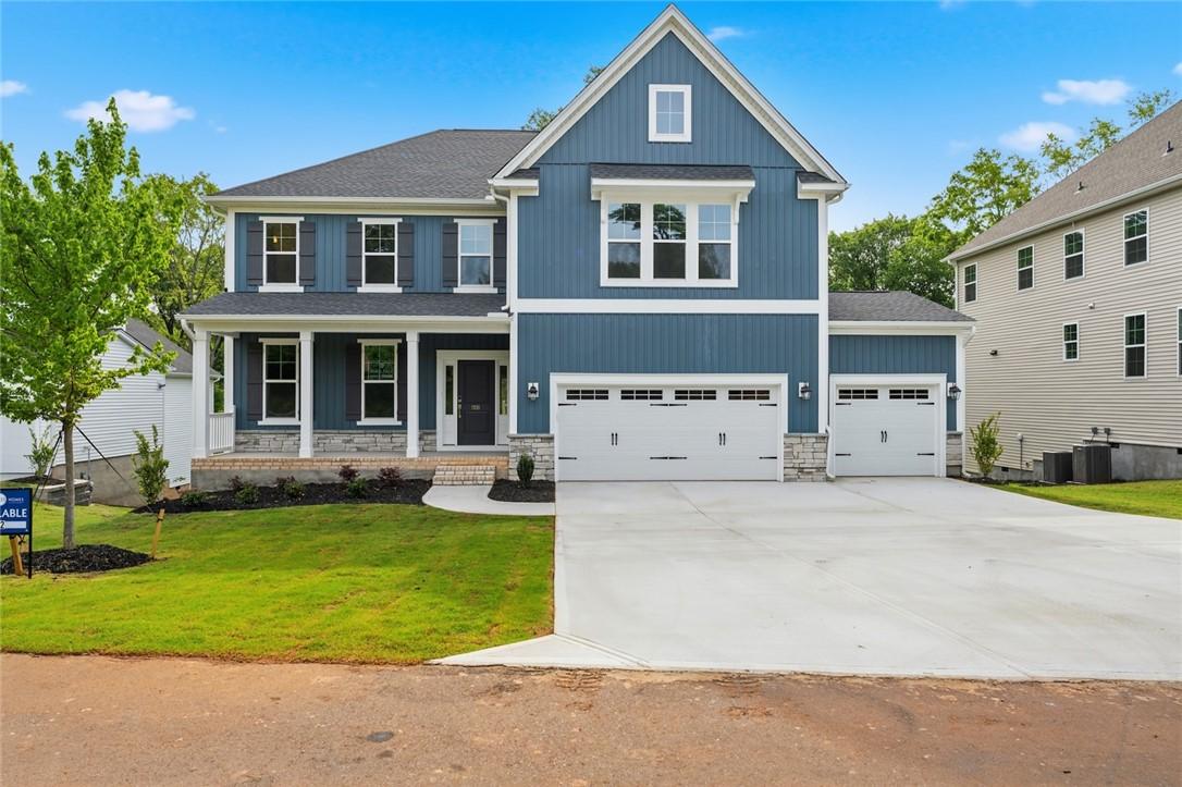 Image 1: This newly constructed home boasts a classic facad