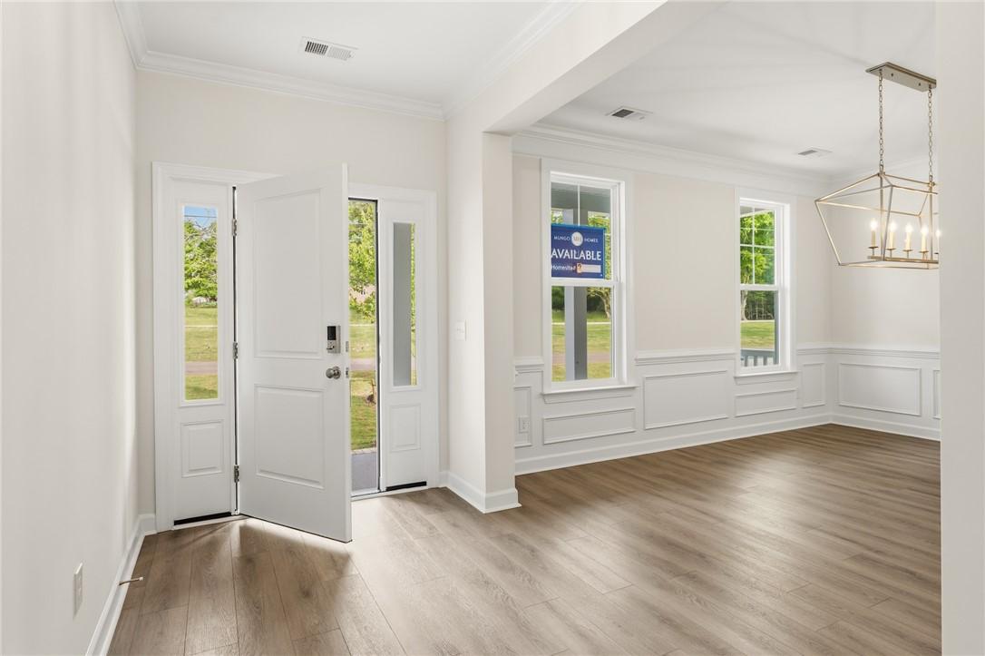 Image 3: This bright entry opens into a versatile room, sho