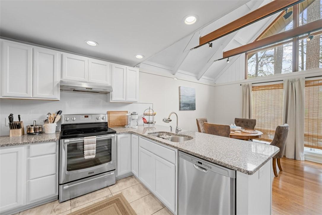 Image 2: This kitchen features sleek countertops, modern ap