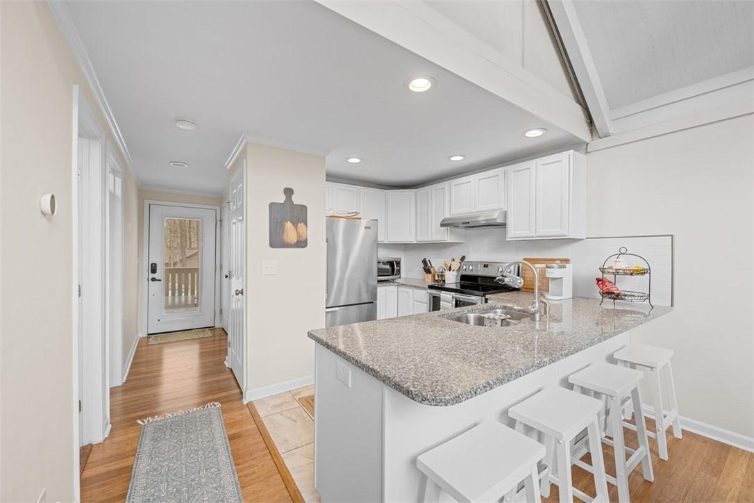 Image 4: This bright kitchen features ample counter space,