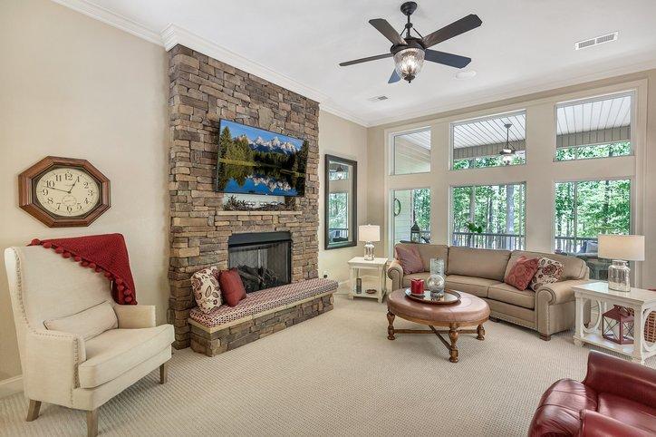 Image 3: This inviting living area boasts high ceilings, a