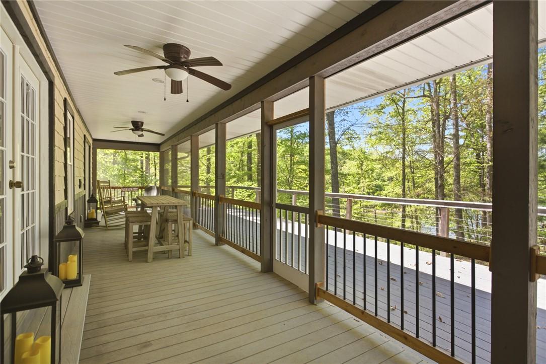 Image 3: This screened porch offers serene tree and lake vi