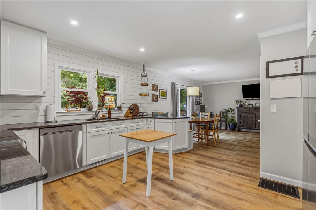 Image 3: A well-appointed kitchen features ample counter sp