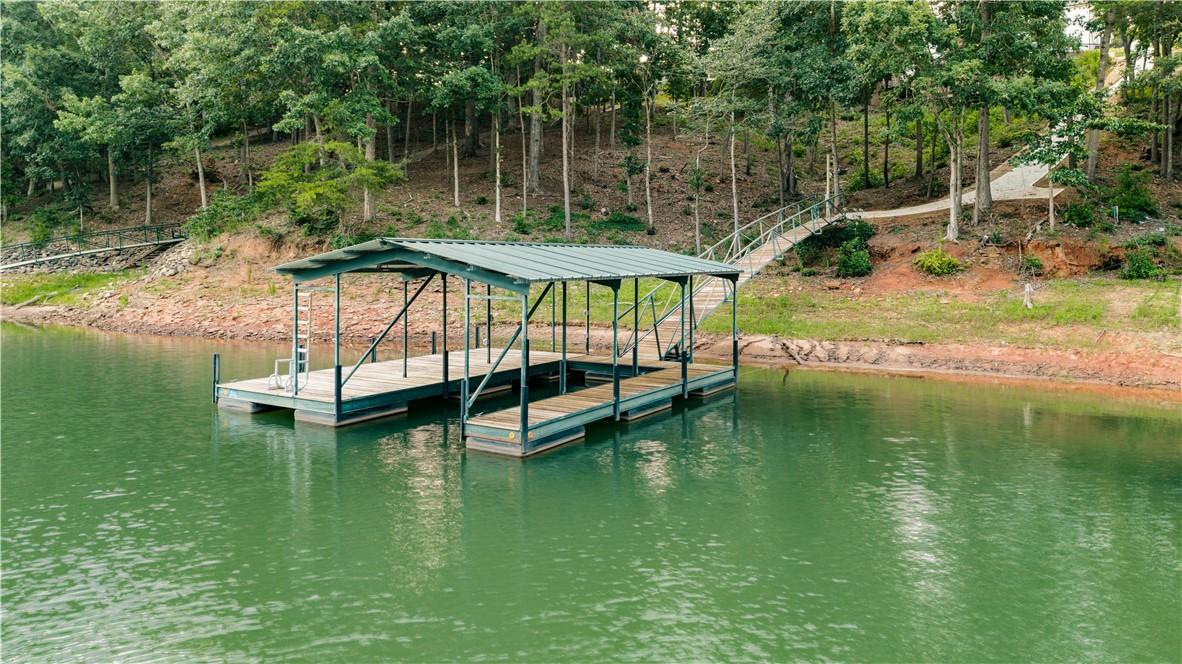 Image 2: A private boat dock extends over tranquil waters,