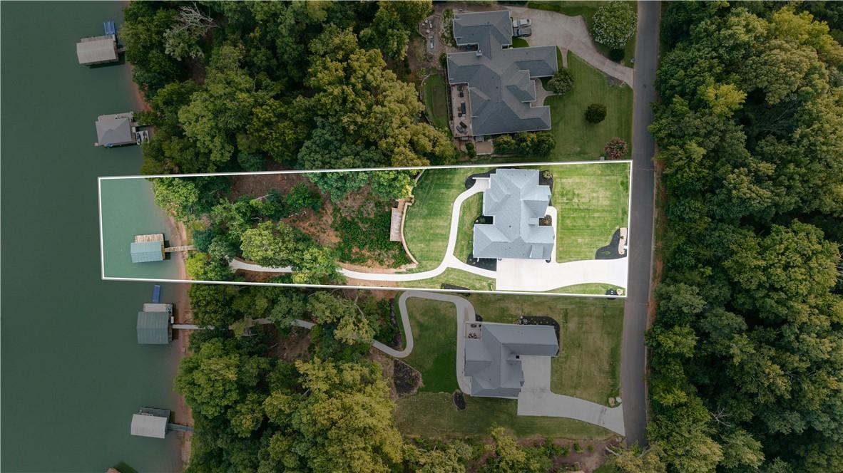 Image 4: A spacious lakeside lot featuring a manicured lawn