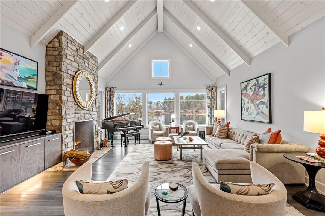 Image 4: An inviting living room features a stone fireplace
