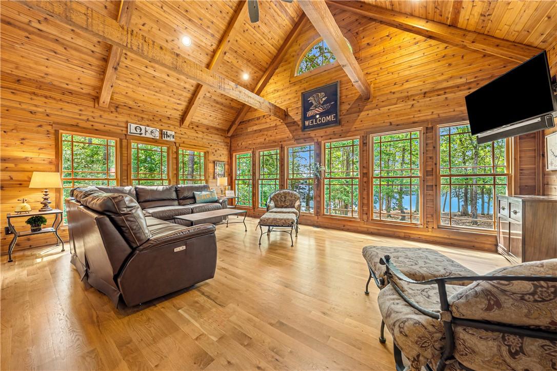 Image 3: A spacious living area with soaring vaulted ceilin