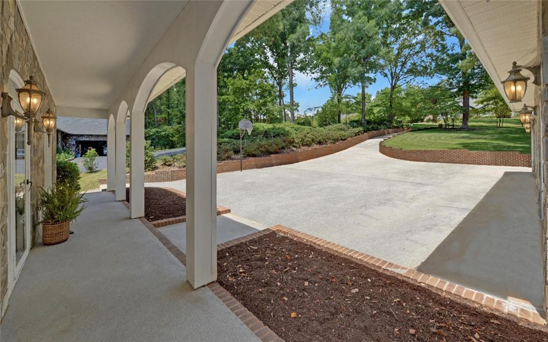 Image 2: A graceful arched walkway leads to a spacious conc
