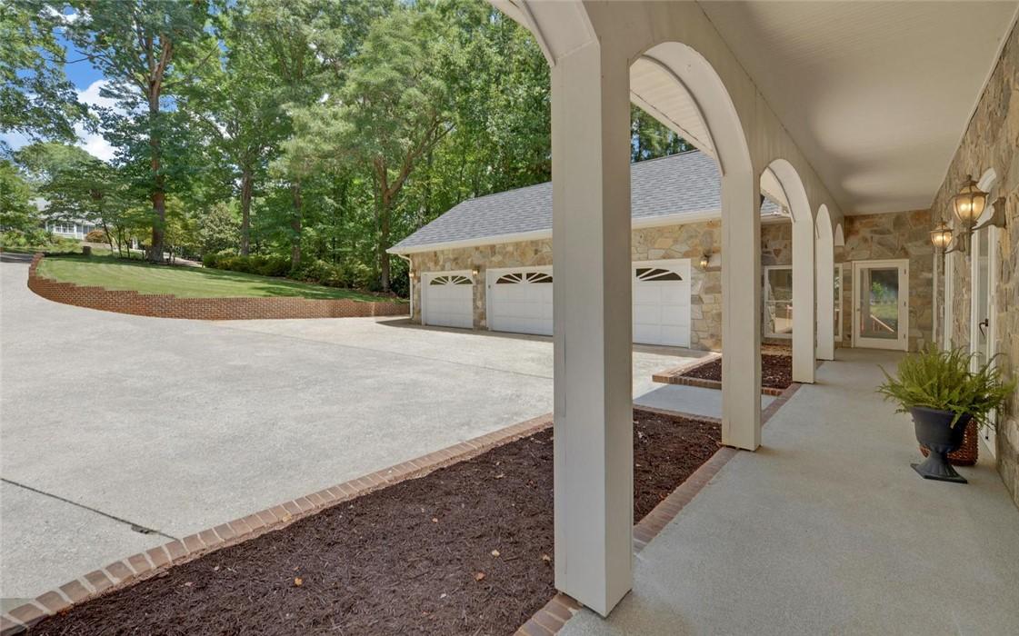 Image 3: Stone construction and arched walkways define the