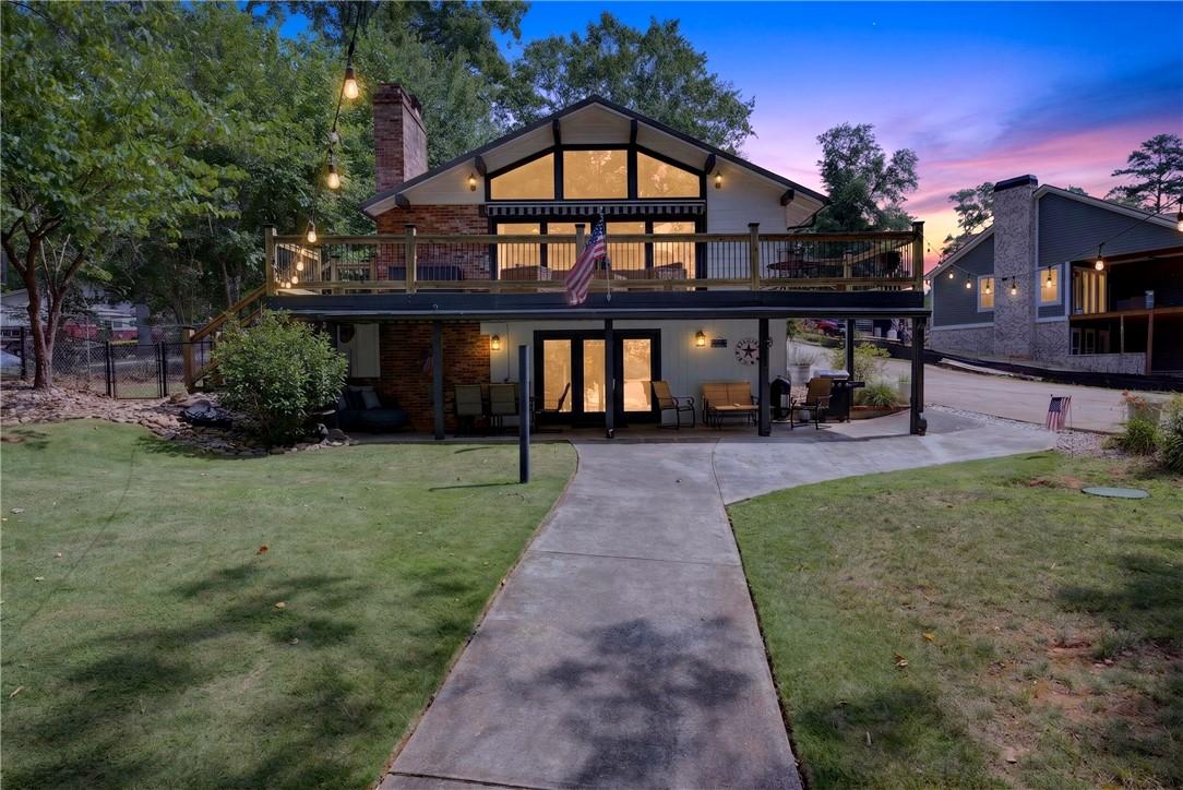 Image 1: Gable roofline and ample fenestration define this