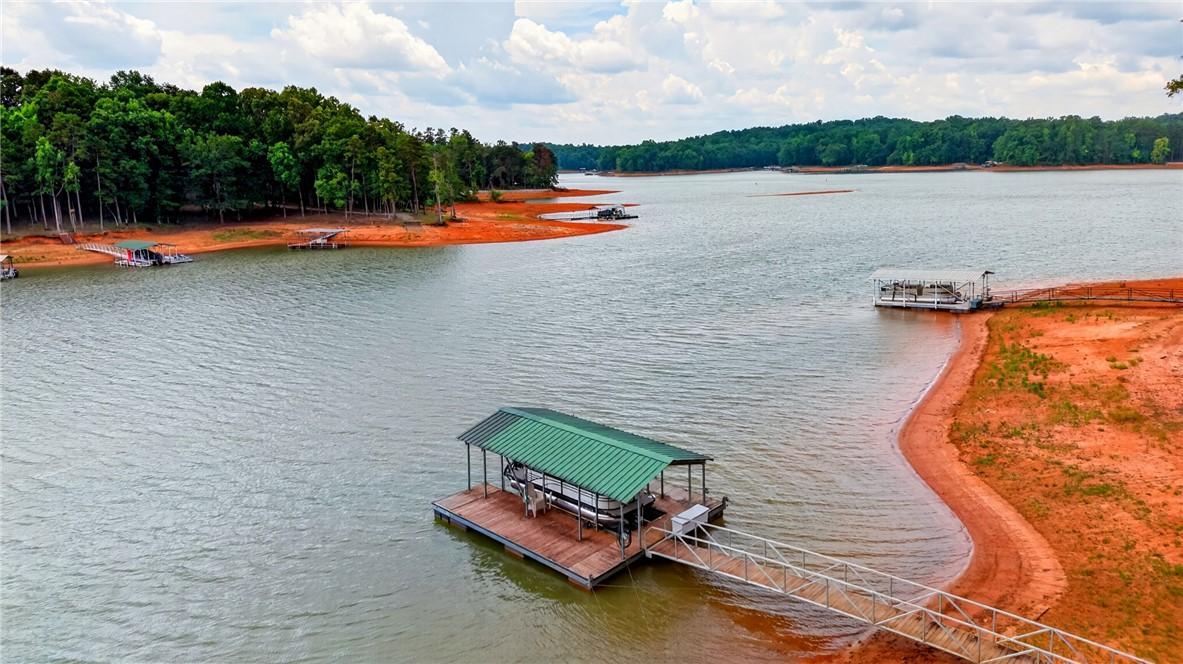Image 3: A tranquil lake view unfolds with private boat doc