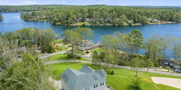 Image 3: Perched above a lake, this serene property feature