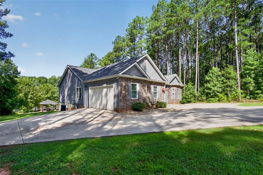 Image 2: A welcoming home with a two-car garage, surrounded