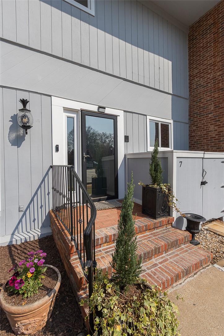 Image 4: This charming entrance features brick steps, a wro