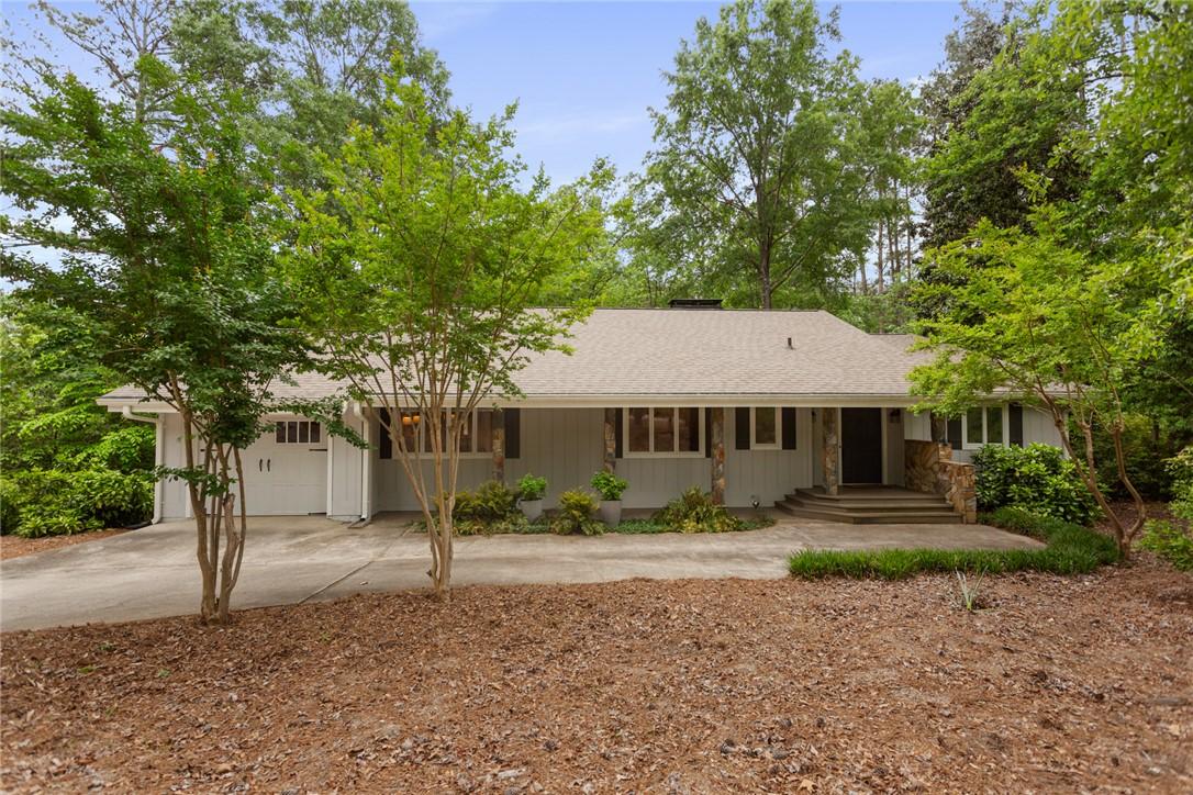 Image 1: This ranch-style home features a classic design wi