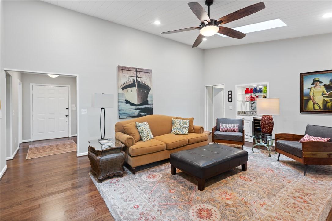 Image 4: This inviting living area boasts high ceilings and