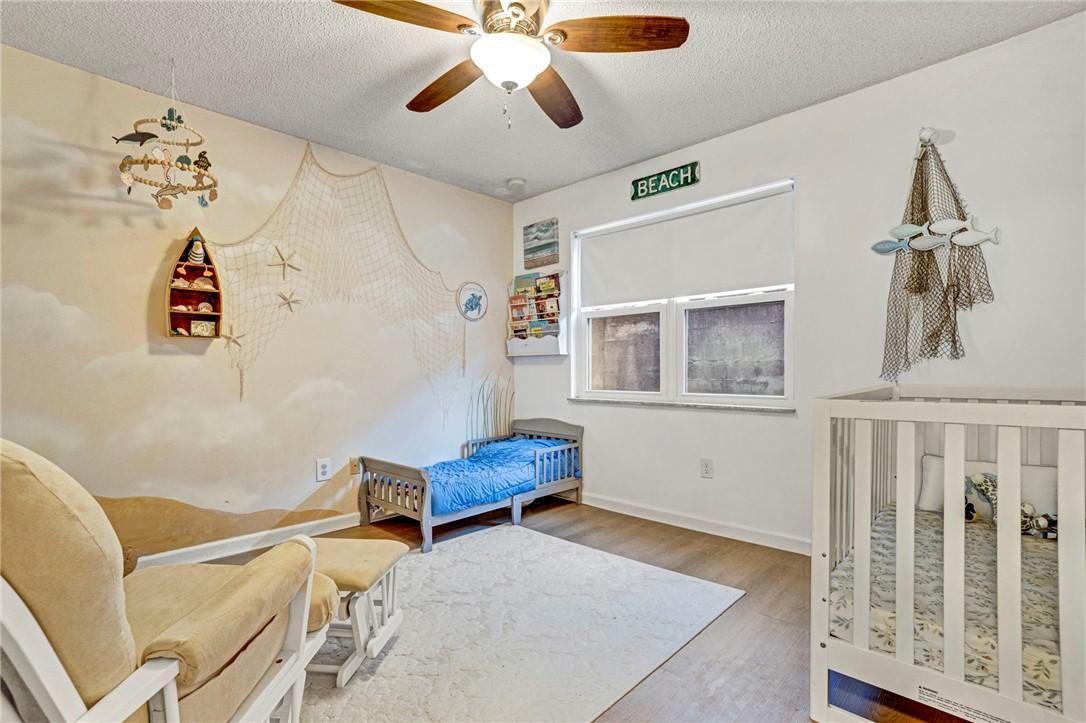 Image 2: This cozy bedroom features durable flooring and a