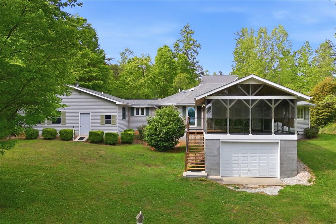 Image 2: This charming home offers a serene escape, surroun