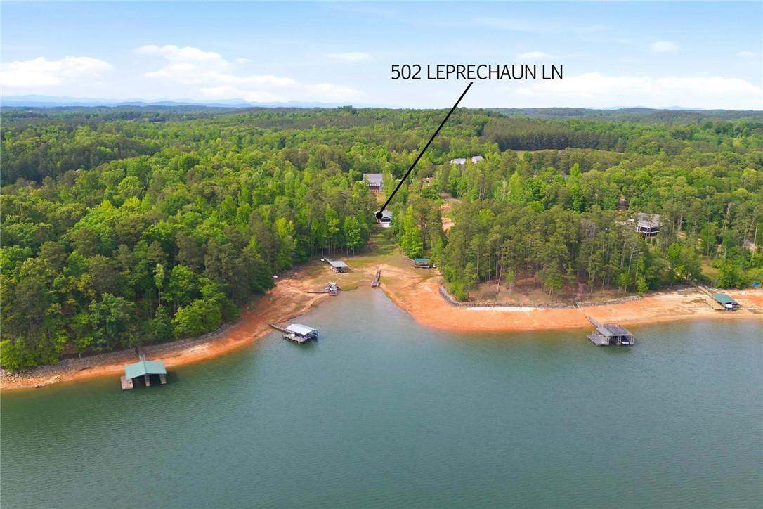 Image 4: Perched above a serene lake, this expansive proper