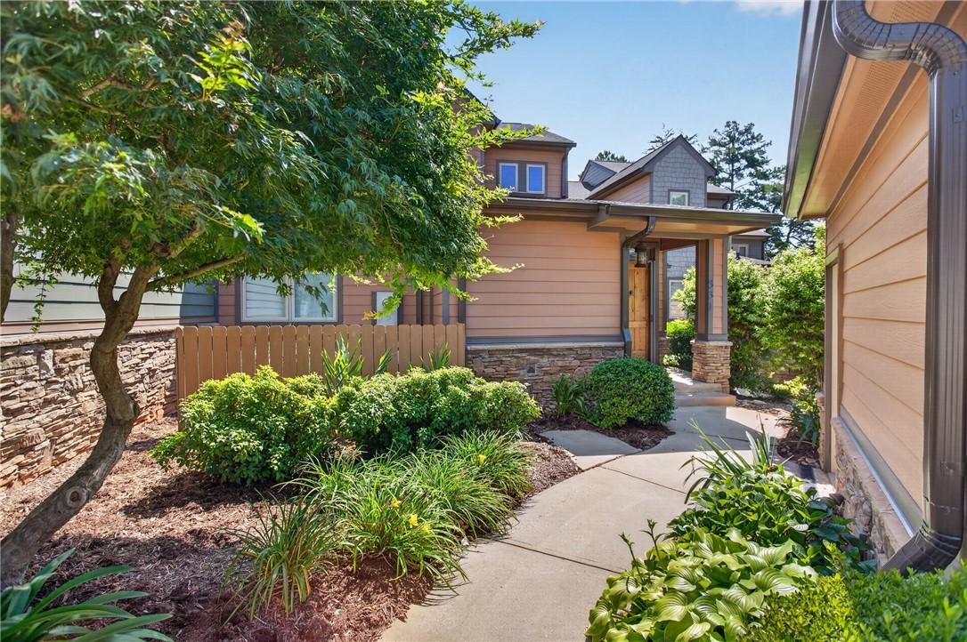 Image 3: A welcoming walkway leads to a well-maintained hom
