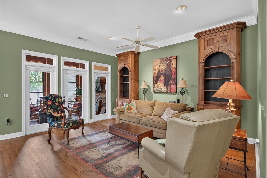 Image 4: Natural light streams into this living area, showc