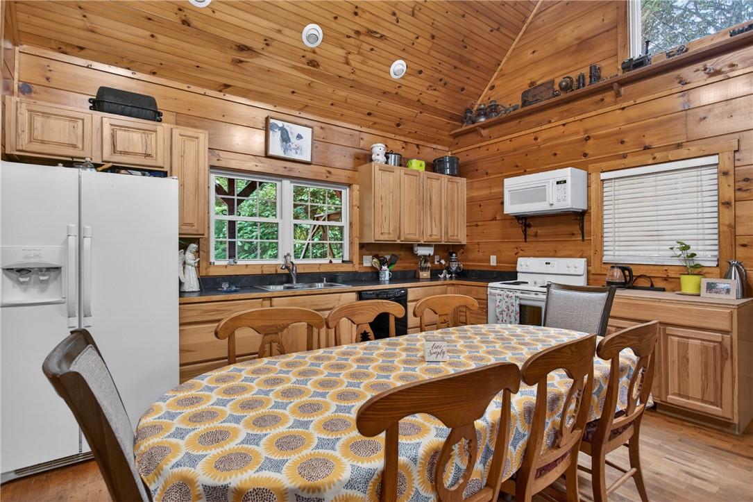 Image 4: A rustic cabin kitchen boasts ample cabinetry and