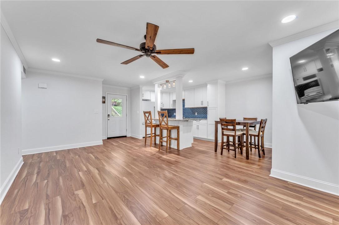 Image 4: Natural wood flooring complements this open-concep