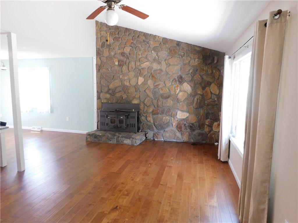 Image 4: A striking stone fireplace hearth anchors this spa