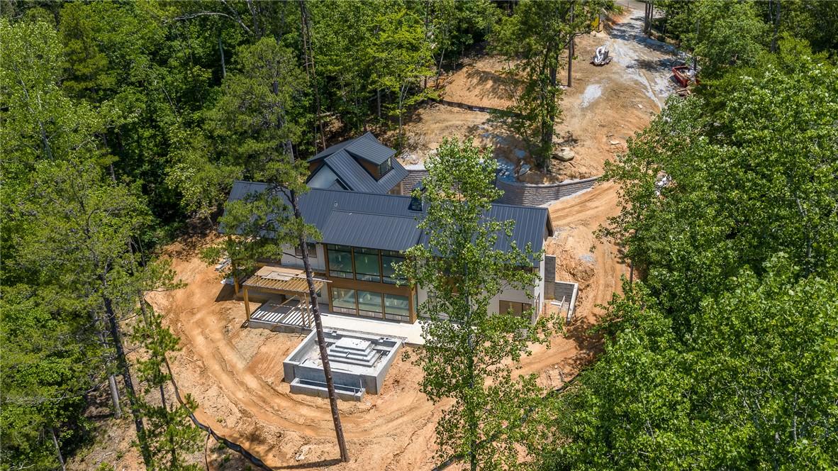 Image 3: Perched among verdant trees, this modern home blen