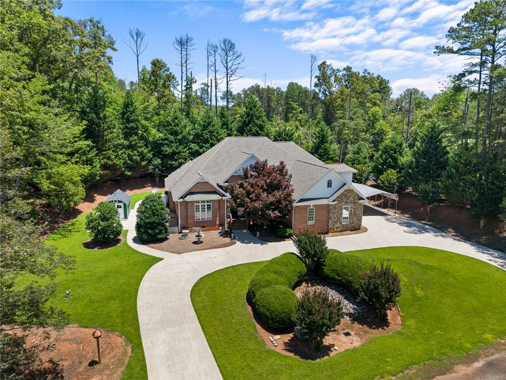 Image 1: A winding driveway leads to this classic brick hom