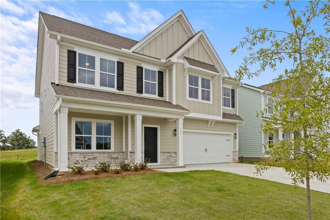 Image 2: A traditional two-story home with a pristine lawn