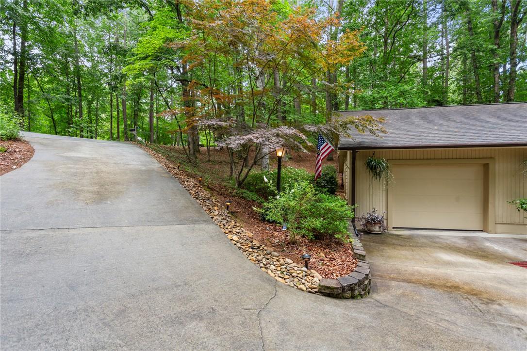 Image 2: A lengthy concrete driveway leads to the residence