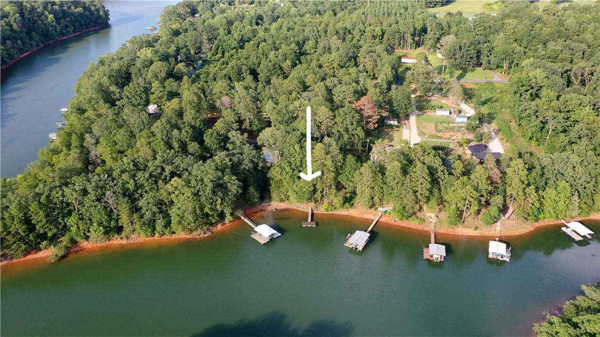 Image 1: A tranquil lakefront property awaits, offering dir