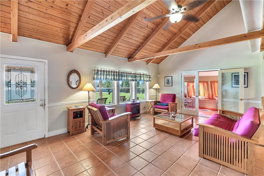 Image 3: A vibrant living space with a vaulted wood-paneled