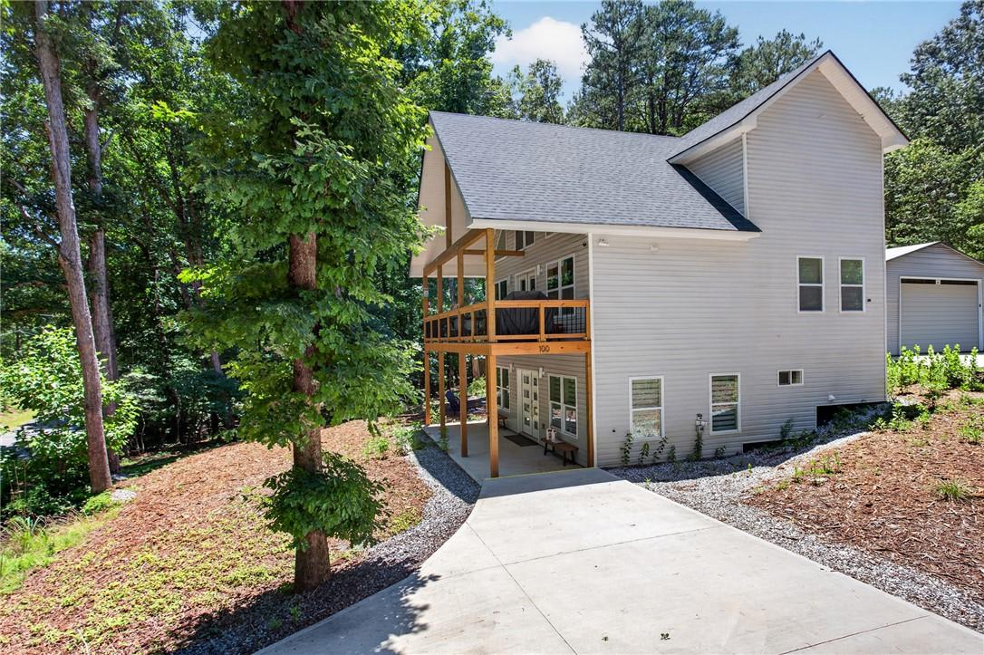 Image 2: A private driveway leads to a modern home, envelop
