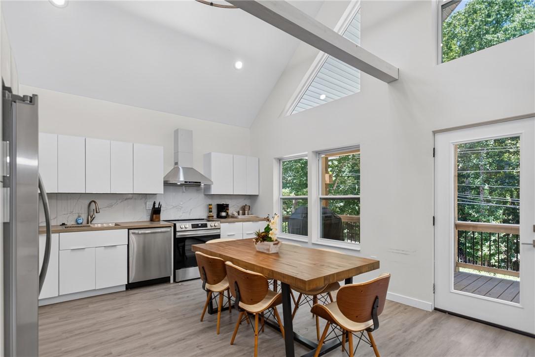 Image 3: A contemporary kitchen features bright white cabin