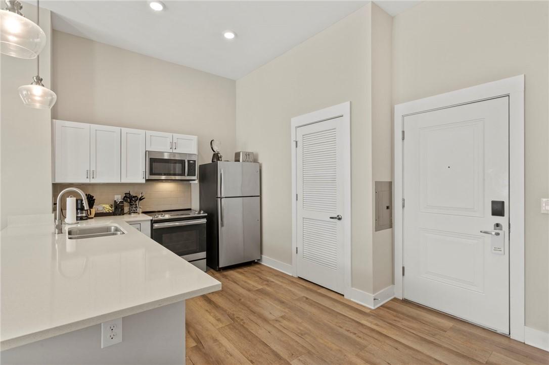 Image 2: A compact kitchen with sleek appliances and light-