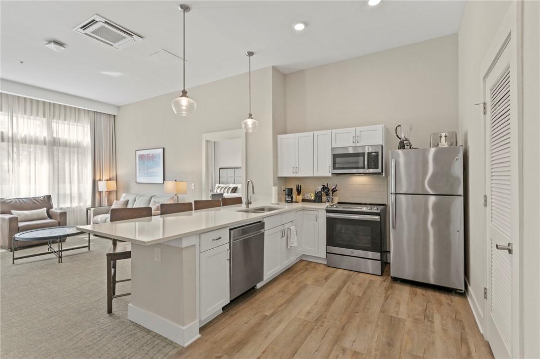 Image 3: A well-lit kitchen with sleek appliances and ample