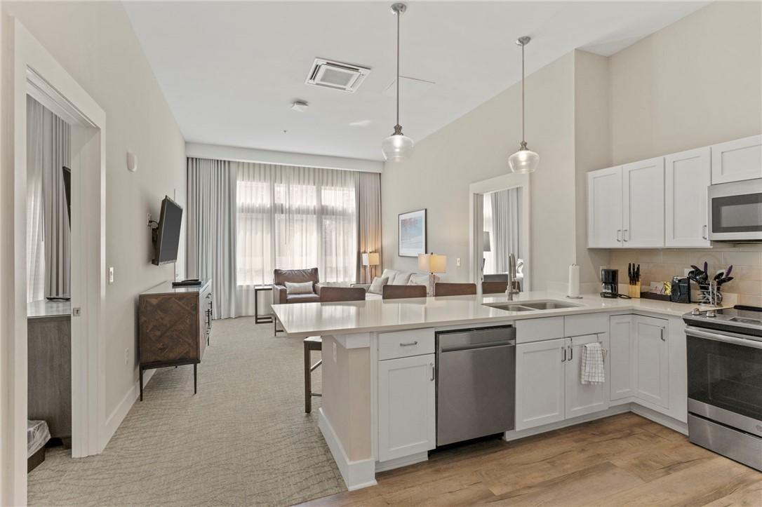 Image 4: An open concept living area seamlessly blends a we