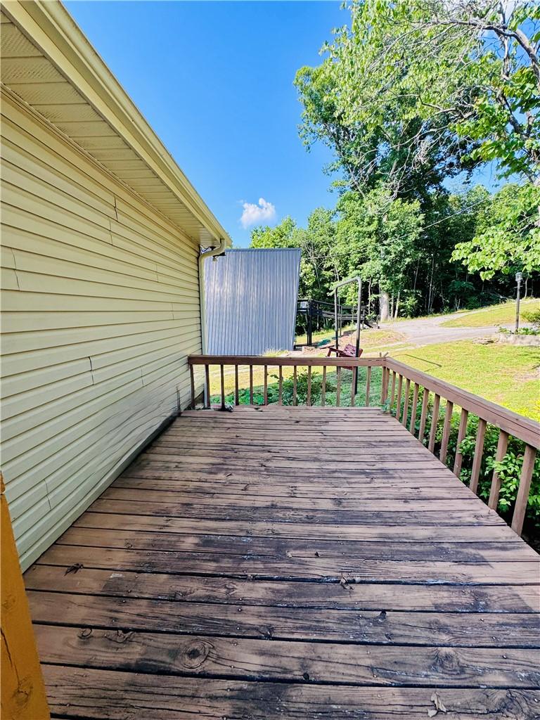 Image 3: A deep wooden deck extends, offering open-air leis