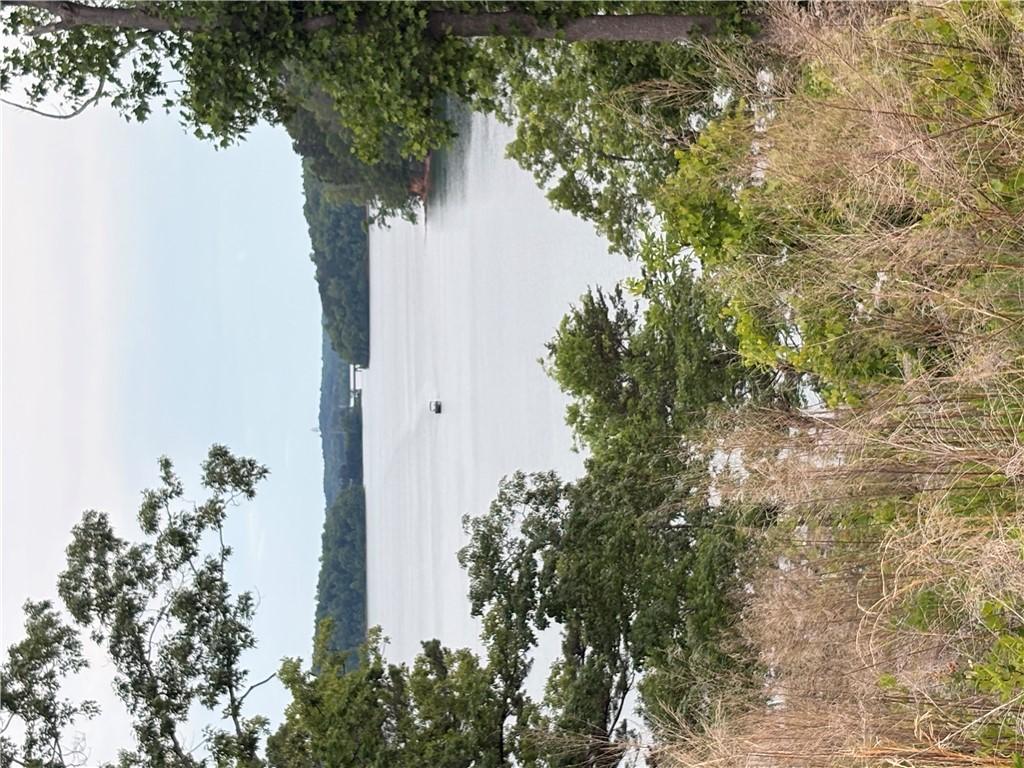 Image 2: Natural scenery frames a tranquil lake, promising
