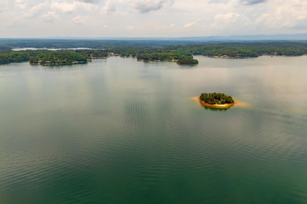 Image 4: An aerial panorama reveals a vast, serene lake dot