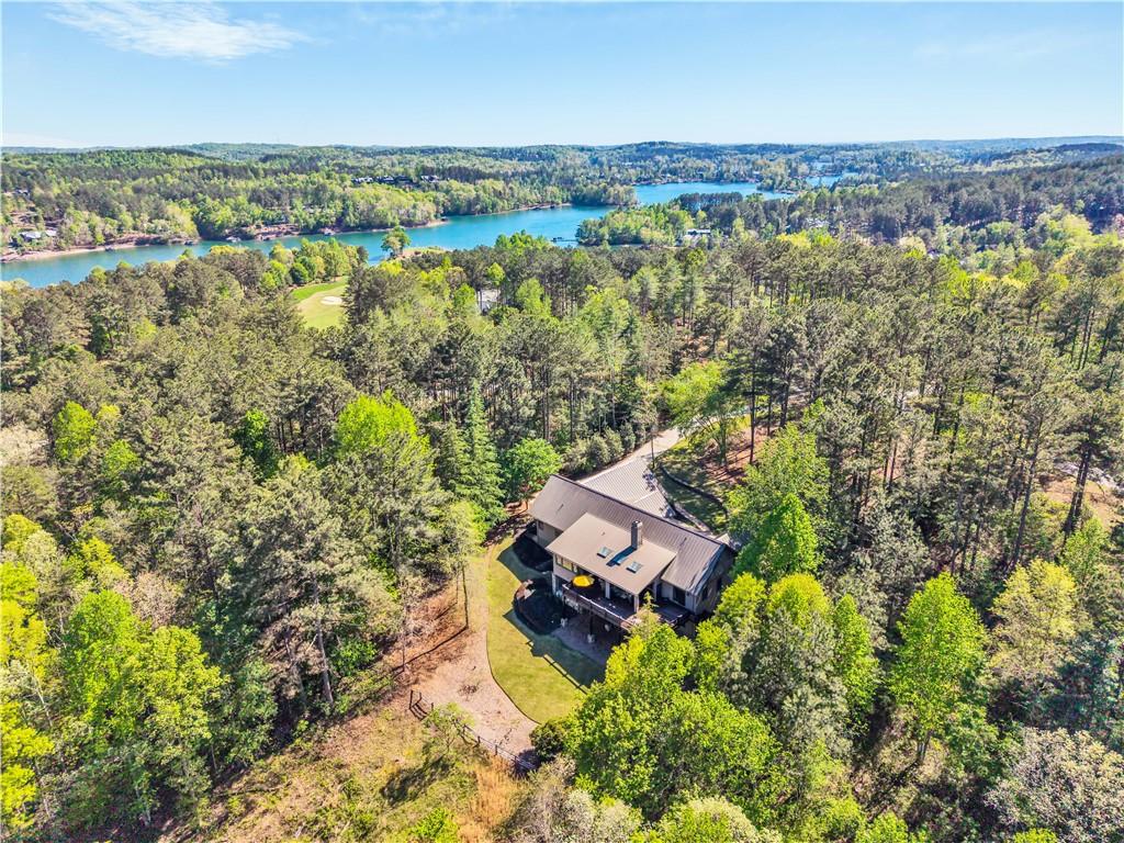 Image 2: Perched amidst verdant trees, this property offers
