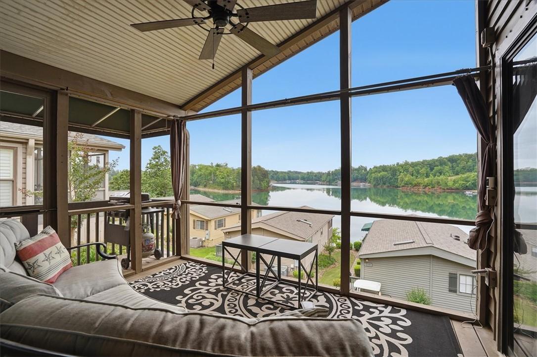 Image 3: A spacious screened porch offers unparalleled lake