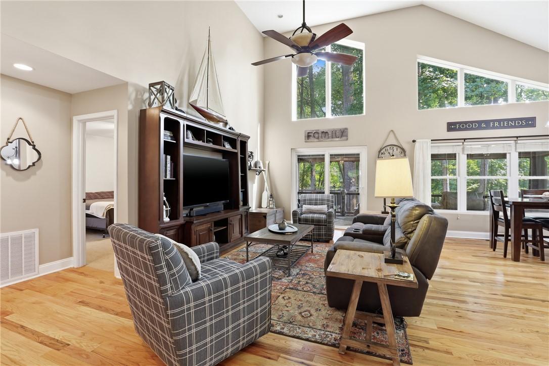Image 4: A spacious living area features lofty ceilings, a