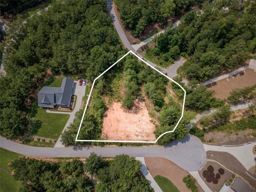 Image 1: A spacious, undeveloped lot awaits your vision, fr