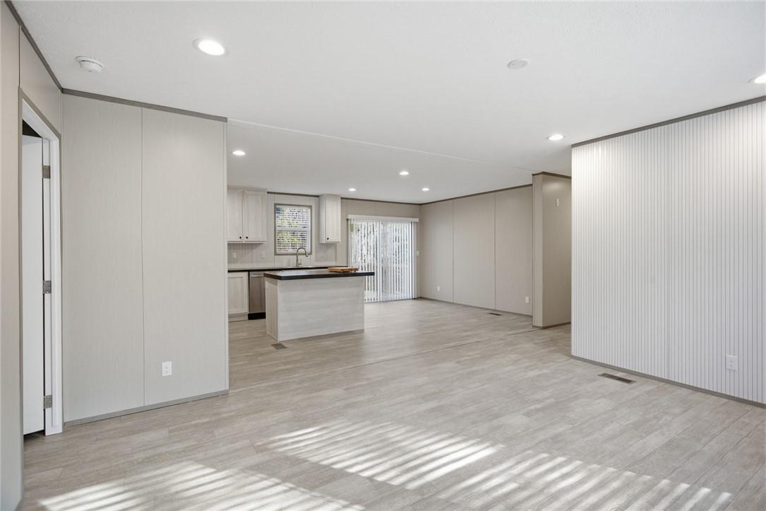 Image 2: This expansive open concept space features a kitch