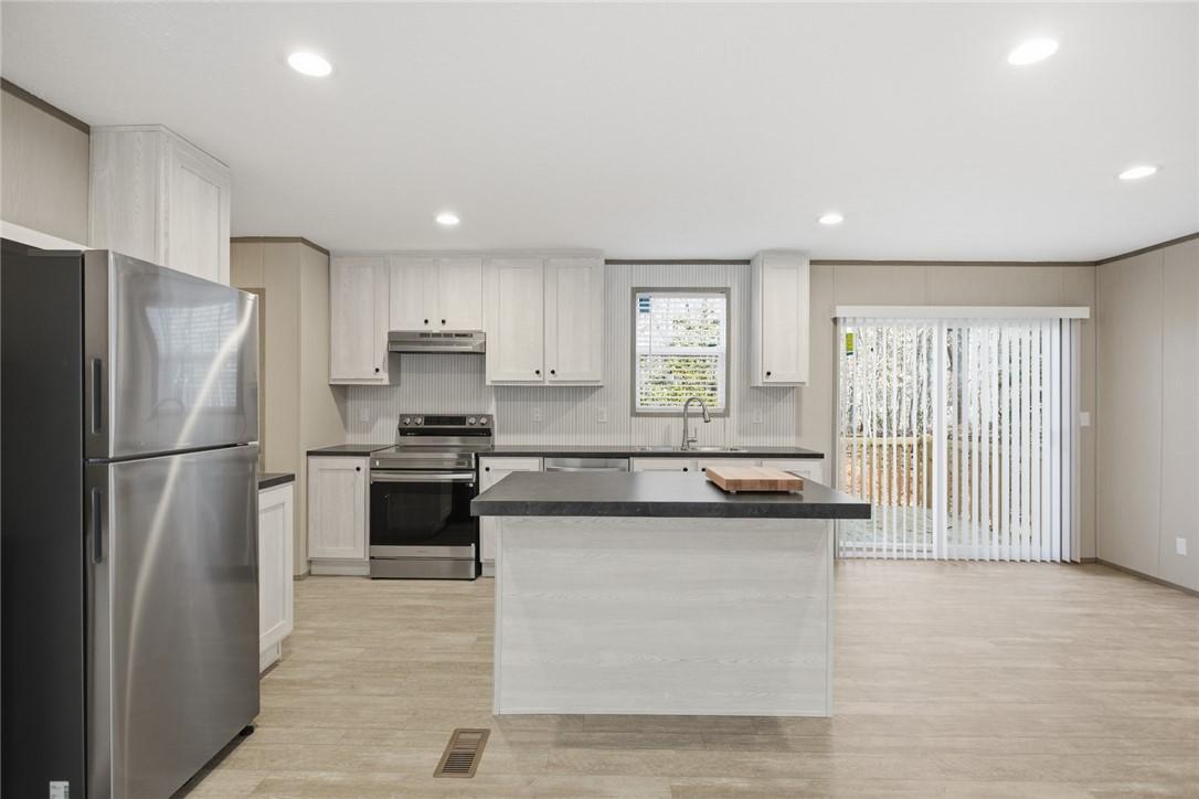 Image 4: This kitchen features a bright, open-concept desig